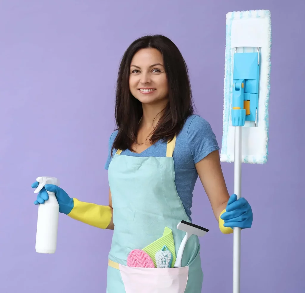 smiling cleaning lady holding a mop and cleaning products