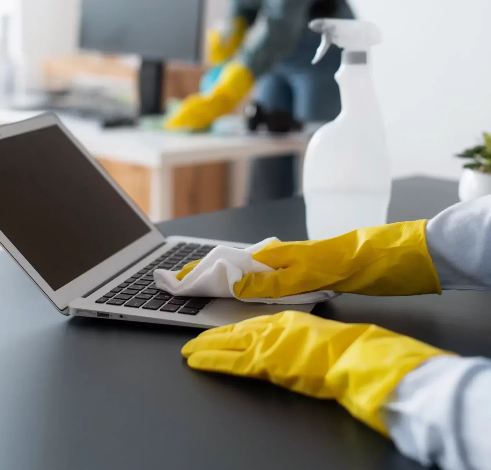 professional cleaners cleaning office electronics