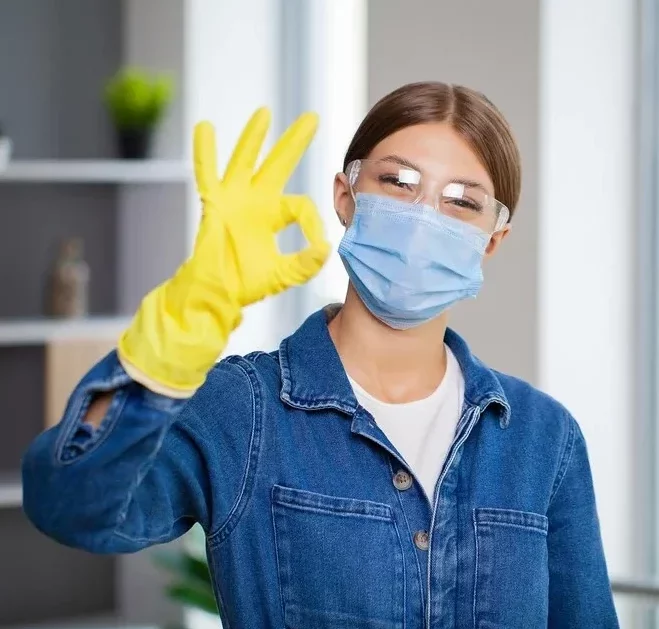 professional cleaning lady wearing a mask and a glove