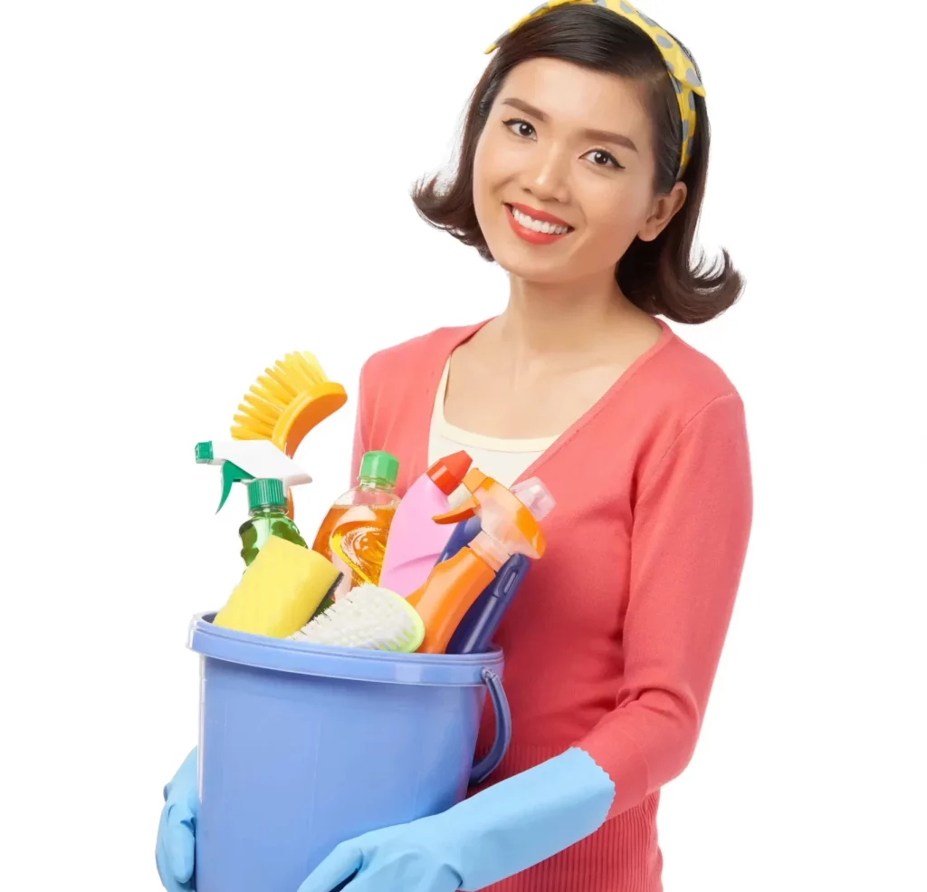 young woman smiling while holding a bucket full of cleaning products